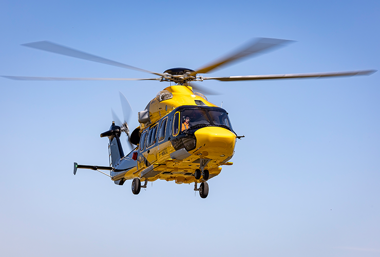 Yellow Airbus H175 Helicopter in the sky